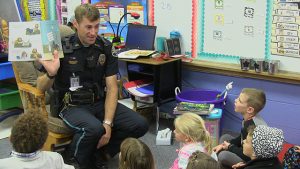 Police officer reads to children