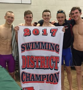 Linn-Mar Boys Swim Team Holding 2017 District Swimming Champion Banner