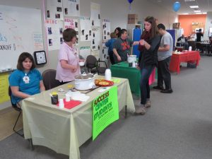 People sample chili during a chili cook off