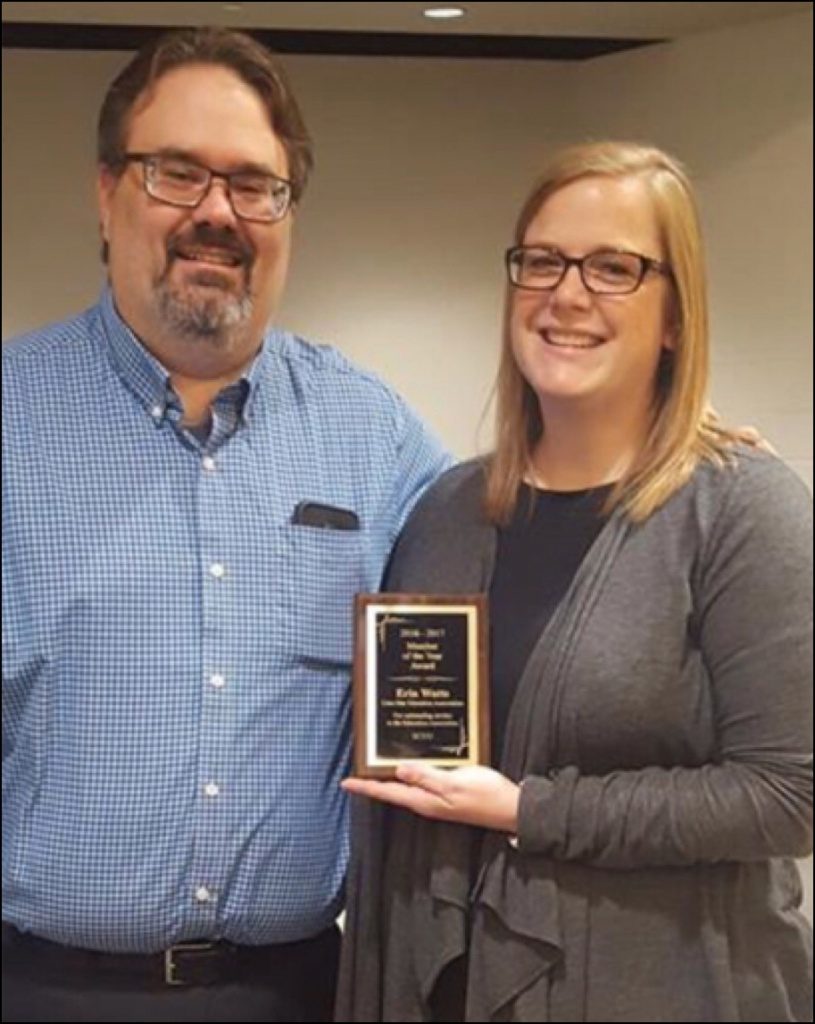 Jeremy Kunz from East Central Uniserv Unit awards Linn-Mar Education Association's Erin Watts with a Member of the Year award