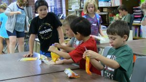Students holding bags of homemade slime