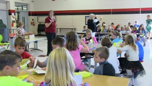 Local Elks Club members discuss the dictionary with 3rd grade students