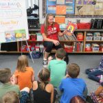 Heather T. reads to students at Wilkins Elementary