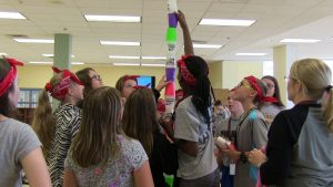 Students stacking cups into tall tower at Oak Ridge