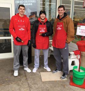 Members of the Linn-Mar basketball team ring bells for the salvation army