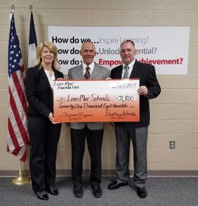 Linn-Mar Foundation members present the Linn-Mar superintendent with a large-sized check