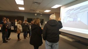 Guests watching slides at Intermediate Open house