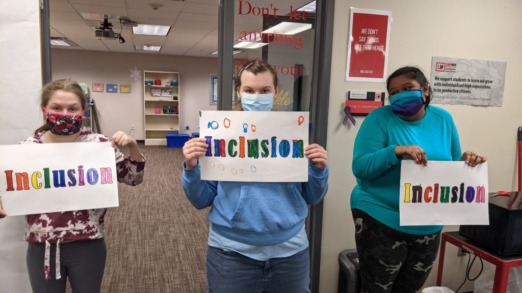 Students holding signs for Inclusion Week