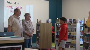 Student shows off Boulder Peak library to guests