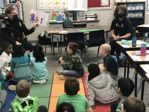 Officer Daubs reads to students