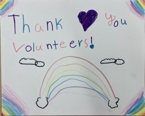 child drawing says thank you volunteers with rainbow